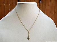 Front view of the 14K gold chain necklace with pendant displayed on a mannequin to show full length and pendant positioning.