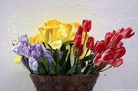 Close-up of artificial flowers inside the diamond pattern vase.