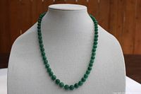 Full view of the green aventurine bead necklace displayed on a bust form, showing the graduated bead sizes and overall length.
