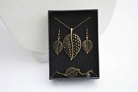 Jewelry set in original gift box including necklace, bracelet, earrings with leaf design