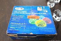 Front view of one unopened blue box of 5 LED Ice Lights showing product branding, multi-colored lights, and color-changing features in English and French.