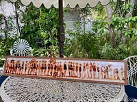 Panoramic view of entire framed photograph showing line of women at 1925 Balboa Bathing Parade on an outdoor table.