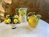 Full view of all three ceramic lemon pottery items on table.