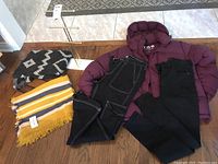 Complete lot with TNA burgundy goose down coat, two wool scarves, jewelry stand, and two denim pants.