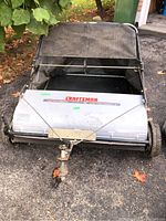 Front view of the Craftsman leaf and lawn sweeper showing body and wheels.