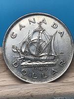 Reverse side of the 1949 Canadian silver dollar, showing the 'Mathew' ship and text 'CANADA DOLLAR 1949 FLOREAT TERRA NOVA'.