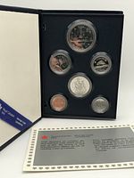 Blue folder holding 6 specimen coins displayed with certificate paper included.