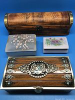 Photo of the four decorative storage boxes arranged on blue surface