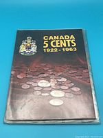 Front cover of the coin book titled 'Canada 5 Cents 1922-1963' with a coat of arms.