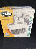 Front view of the Hunter air purifier box with branding and product image showing the unit and family image.