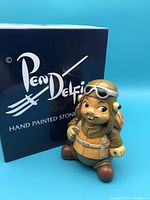 Front view of the Pendelfin Douglas figurine with original box, showing hand painted details and aviator themed costume.