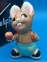 Front view of Pendelfin Pippin rabbit figurine holding an apple, showing facial and costume details