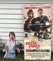 Full view of standee with Chuck Norris cutout showing worn condition