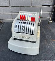 Front view of Speedrite 900 check writer with numbered dials and colored keys.