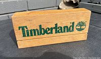Front view of the wooden Timberland display block showing logo and overall condition.