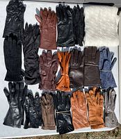 All gloves shown laid out on light surface to show colors and variety in the lot.