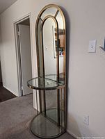 Front view of floor-standing mirror with glass shelves