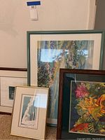 Four framed artworks grouped together showing a variety of themes and frame types.