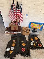 Full lot showing American flags, two Indian Guide vests, a vintage Playskool puzzle, boxes of poker chips, and visible board games