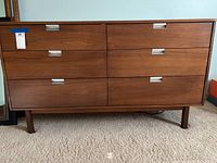 Front view of dresser showing six drawers and silver recessed pulls
