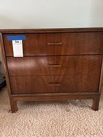 Front view of the nightstand showing two drawers with metal handles and wood grain finish.