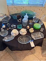 Full collection displayed on table showing various bowls, cups, relish dishes, and animal figurines