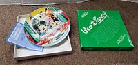 Walt Disney collectible plate with original green box and certificate of authenticity displayed.