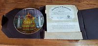 Collectible plate in original box with Certificate of Authenticity displayed on top.