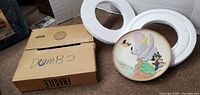 Photo showing the collectible plate with original packaging box and foam inserts labeled 'DUMBO'.