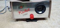 Front of the projector showing Kadet 150 branding, lens, and adjustment knob.