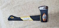 Photo of the Yellow Rockforce hatchet showing front side with Rockforce label, black and yellow synthetic handle, metal blade with some rust