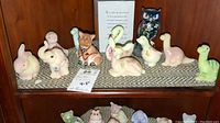 Group shot of all 11 Fenton animal figurines displayed on shelf