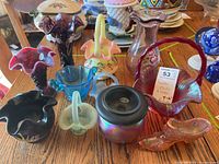 Overview of ten small Fenton glass pieces on tabletop