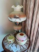 Overview of lamp with shade and two vases on table