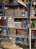Wide view of beige shelving unit loaded with small parts bins and assorted storage cases