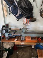 Full view of Delta Midi Lathe on bench with router bit case to right