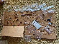 Overview of assorted sterling silver jewelry laid on cardboard