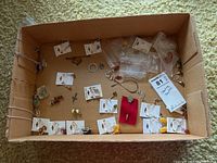Overview of box with assorted sterling silver jewelry pieces