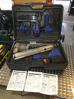 Overview of Campbell Hausfeld air nailer kit in case showing three nailers, various nails and manuals