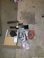 Overview of lot showing Reese adapter, metal panels, wiring cables, filler neck in the box