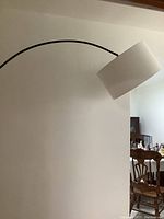 Side view of the curved arm and fabric drum lamp shade