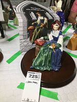 Front view of the Royal Doulton Catherine of Aragon figurine with original box in background on a wooden base.