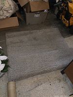 Gray shag rug laid flat showing plush texture, medium gray color, and bound edges.