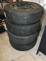 Four tires stacked vertically showing full lot