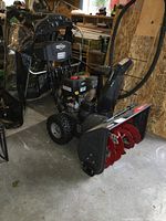 3/4 front view showing engine, auger housing, chute