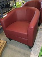 Front and side view of red vinyl tub chair with smooth upholstery showing minor wear, black legs visible, dimensions provided by seller as 30x28x30