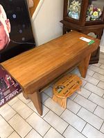 Photo of solid wood bench and wooden stepping stool on floor showing overall shape and size.