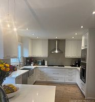 Full view of installed cabinets and countertop under recessed lighting