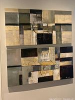 Two abstract geometric paintings on a wall, showing neutral color palette and textures.