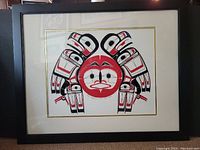 Full view of framed print showing vibrant colors of red, black, and white in a Native art style.
